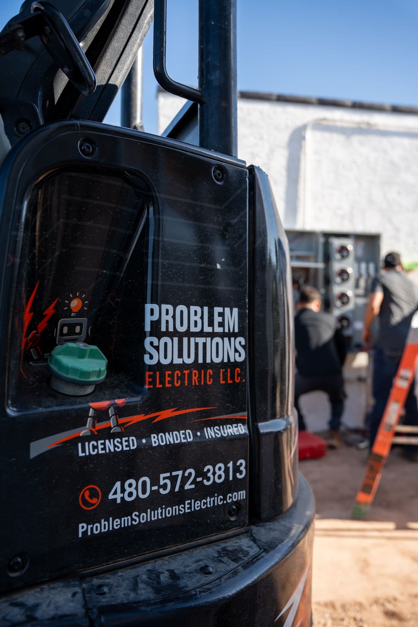 The robot logo and Licensed, Bonded, Insured on a company truck, the crew at a meter stack behind it