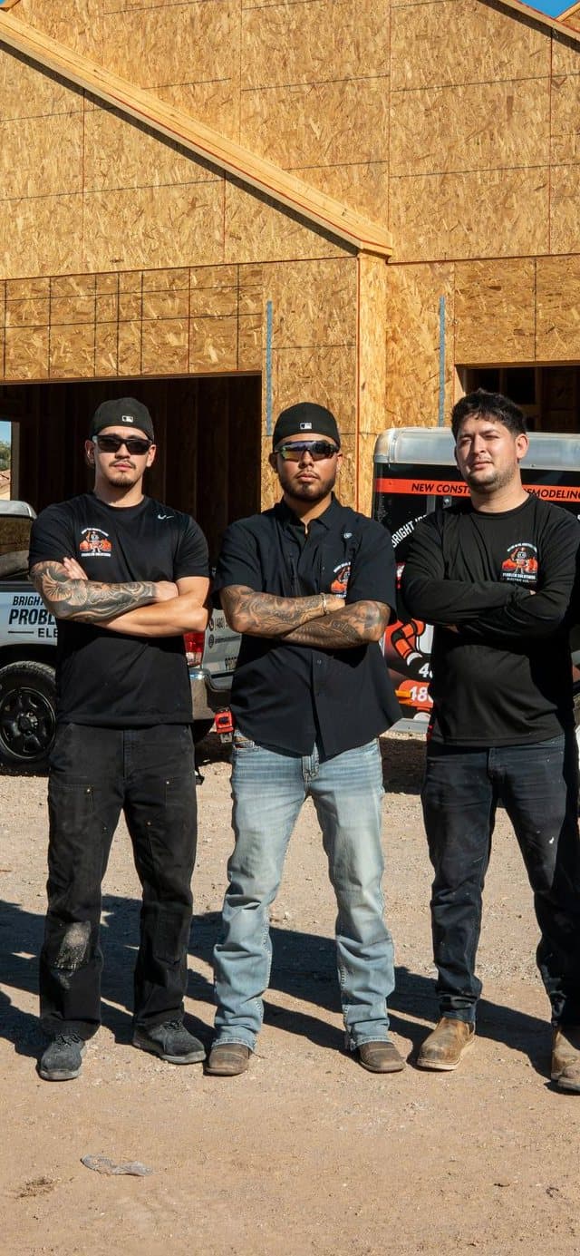 The Problem Solutions Electric crew in front of a custom home they are wiring, with the company trucks and trailer