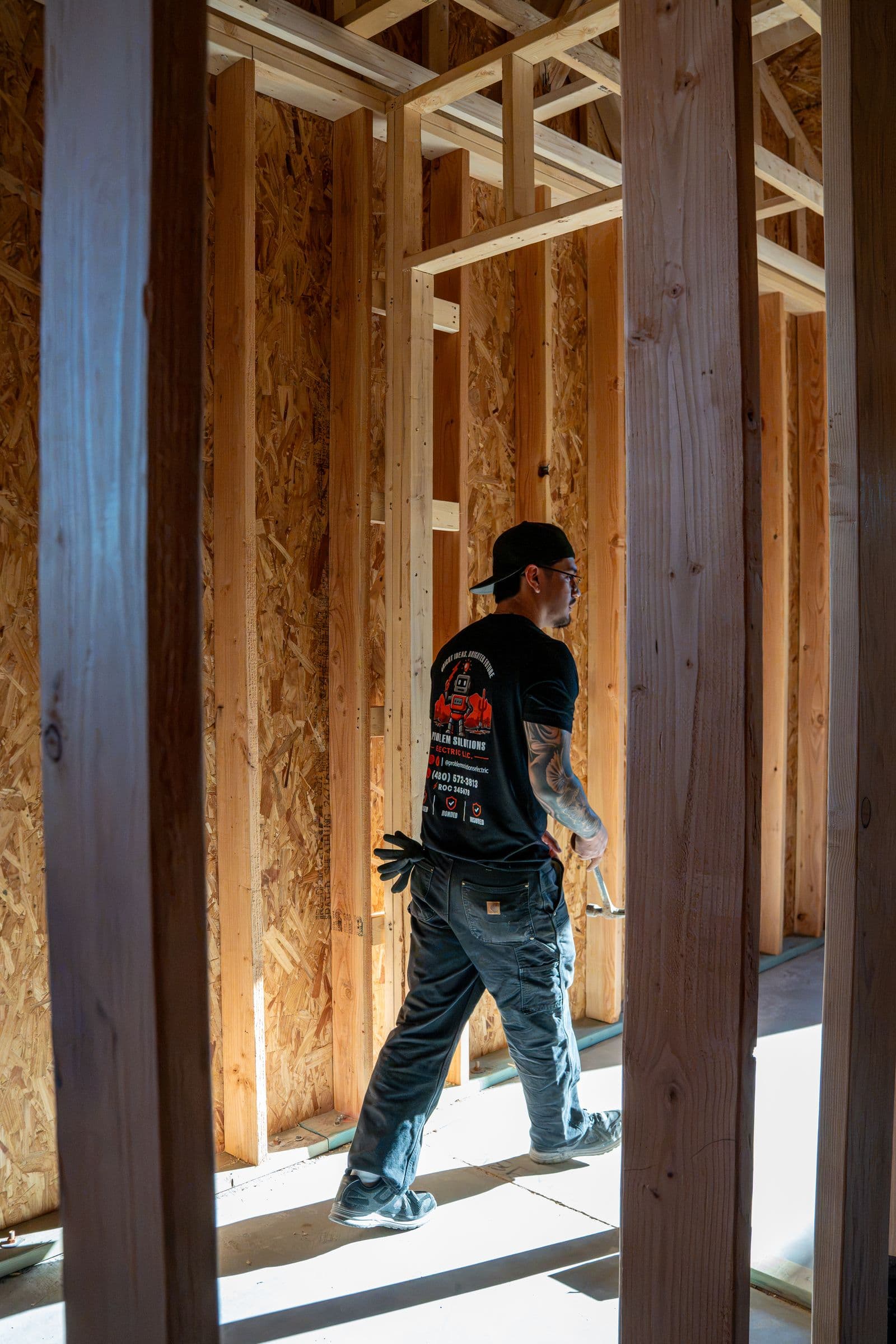 A technician walking through the framing of a new custom home